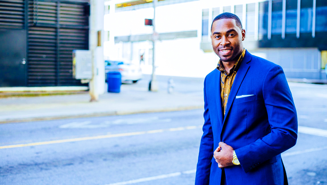Businessman walking down empty city street
