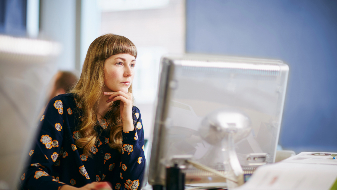 Concerned woman studying a computer screen
