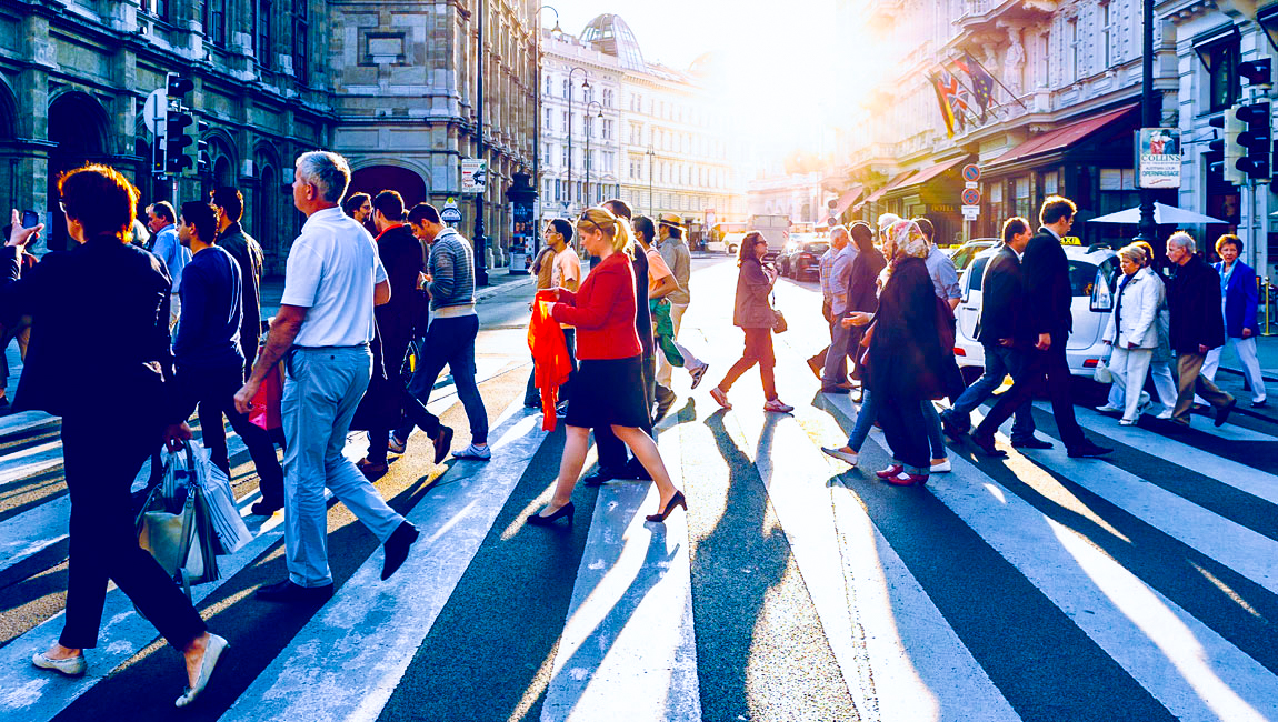 Busy scene of pedestrians crossing crosswalk