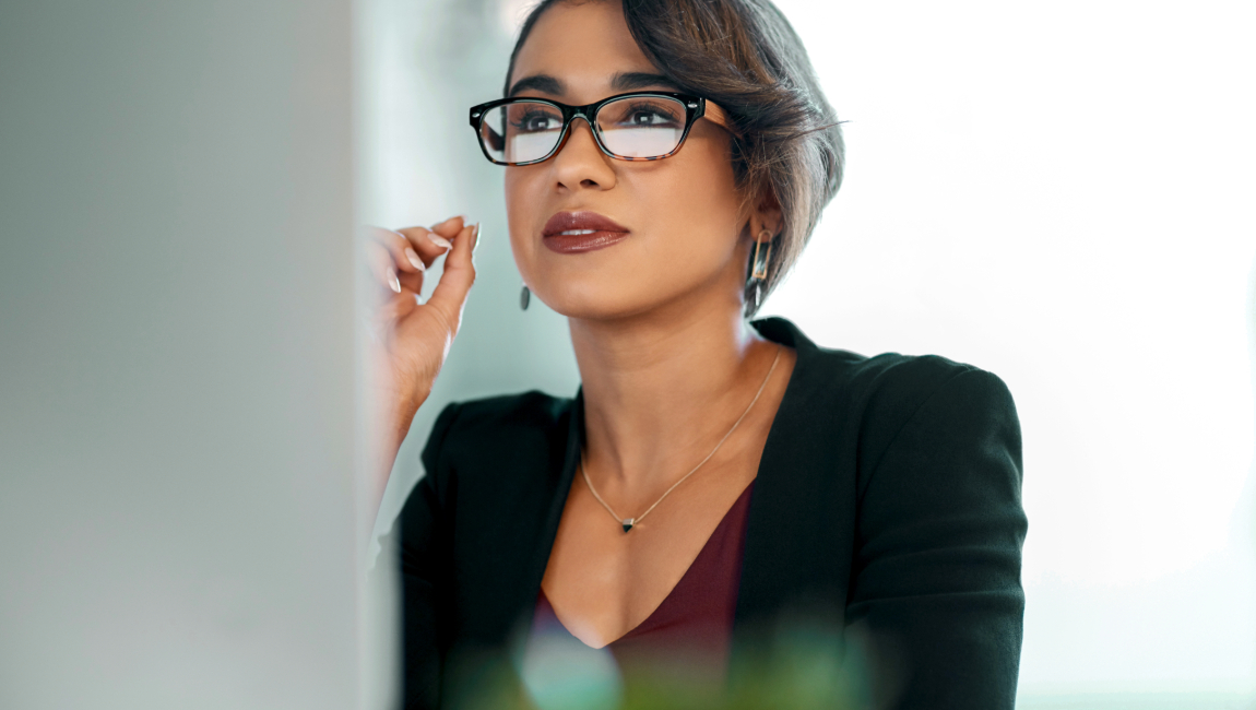 Businesswoman with glasses looking at computer screen