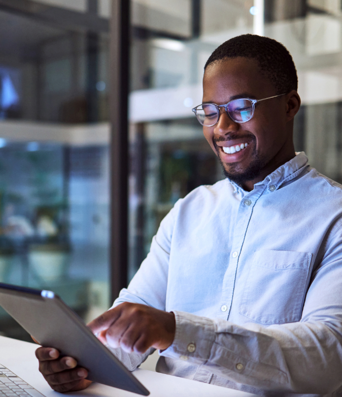 Businessman working on digital tablet late in the office at night